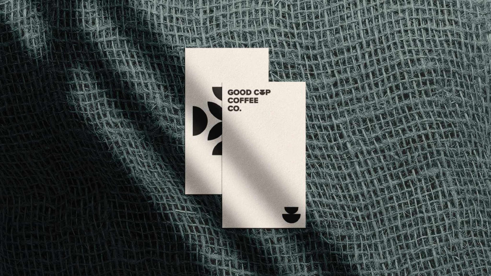 Good Cup business cards resting on woven fabric