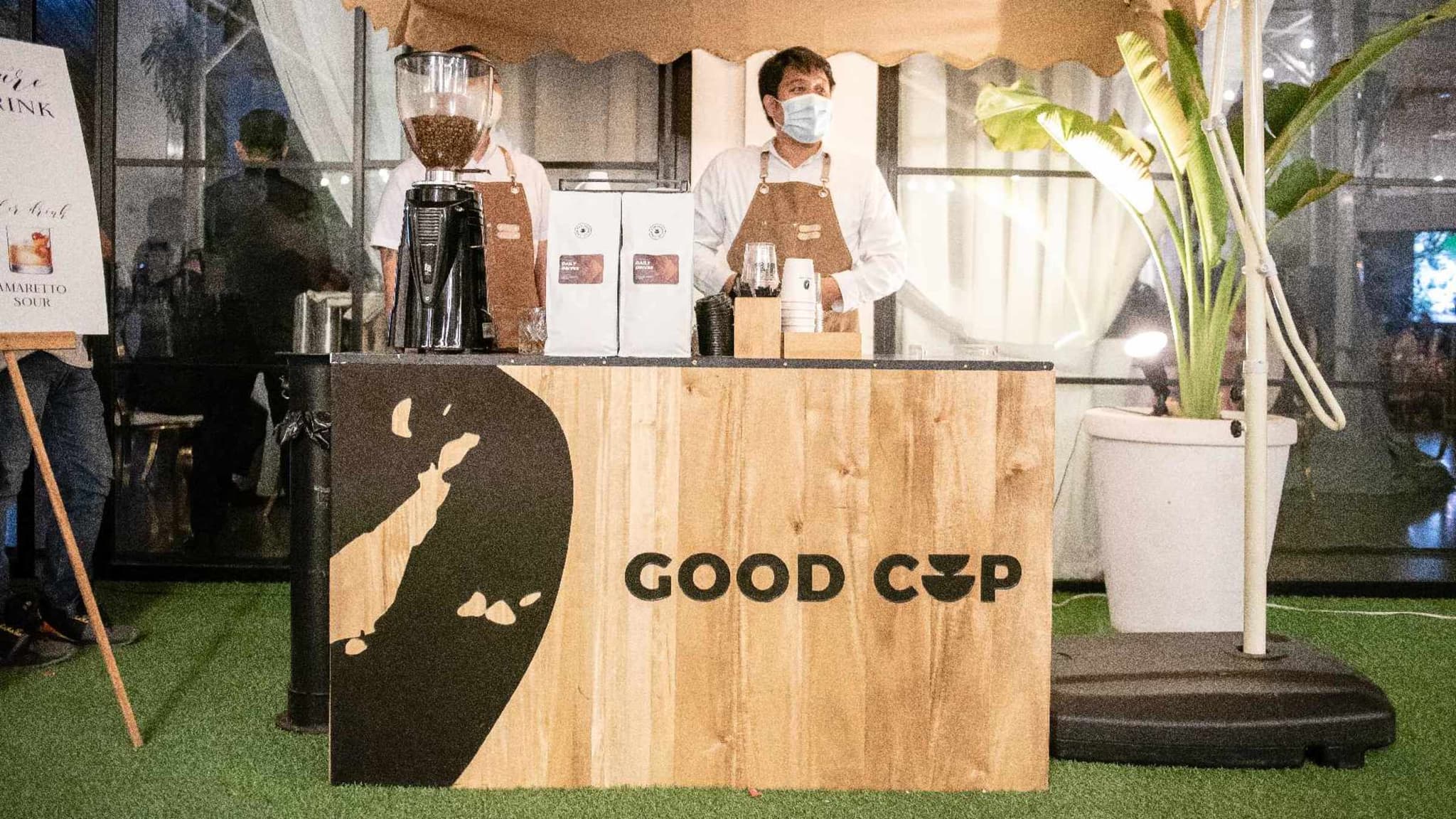 Good Cup pop-up coffee booth with a wooden counter bearing the wordmark