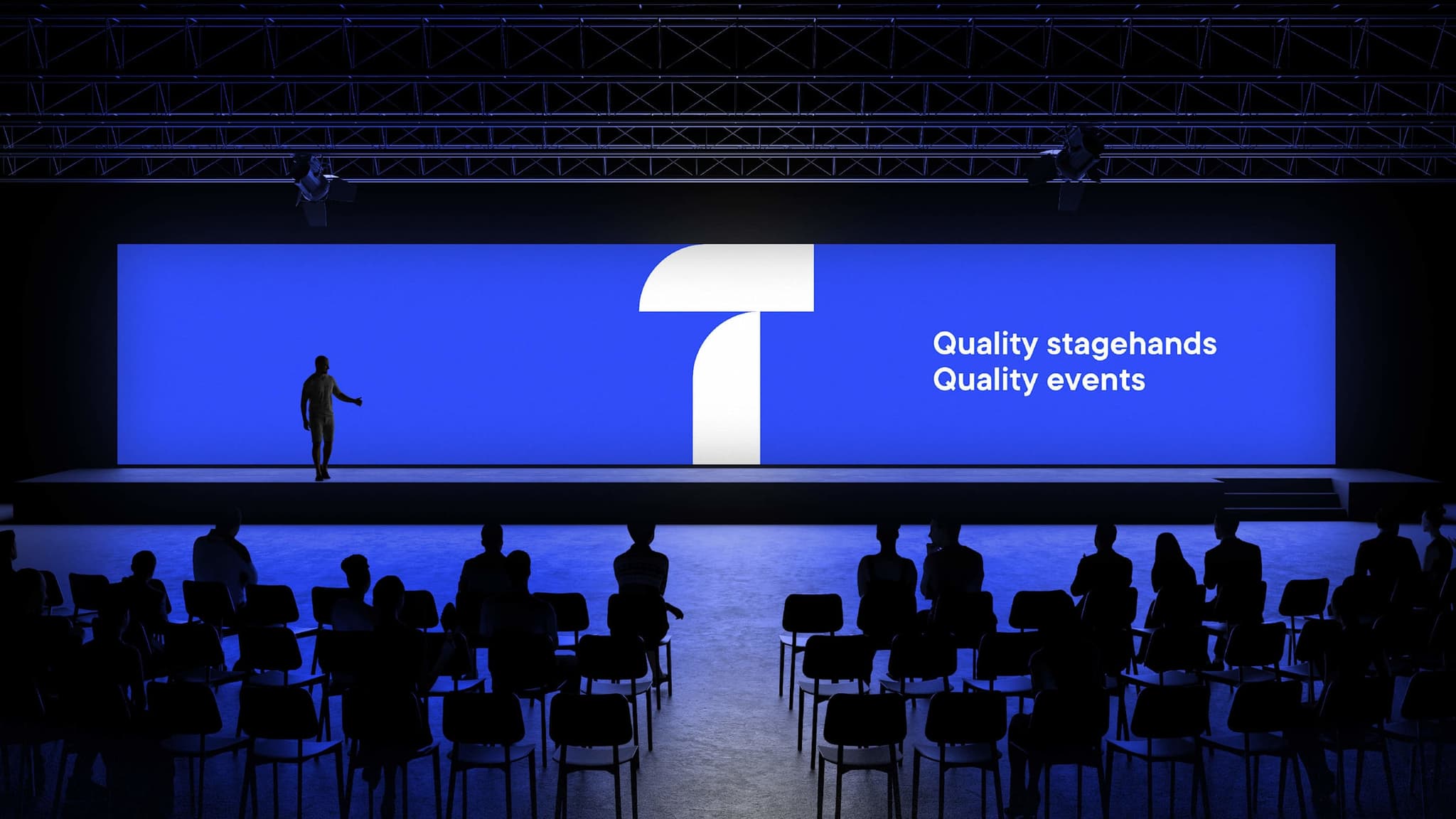 Event stage screen reading “Quality stagehands, Quality events” in front of a seated audience